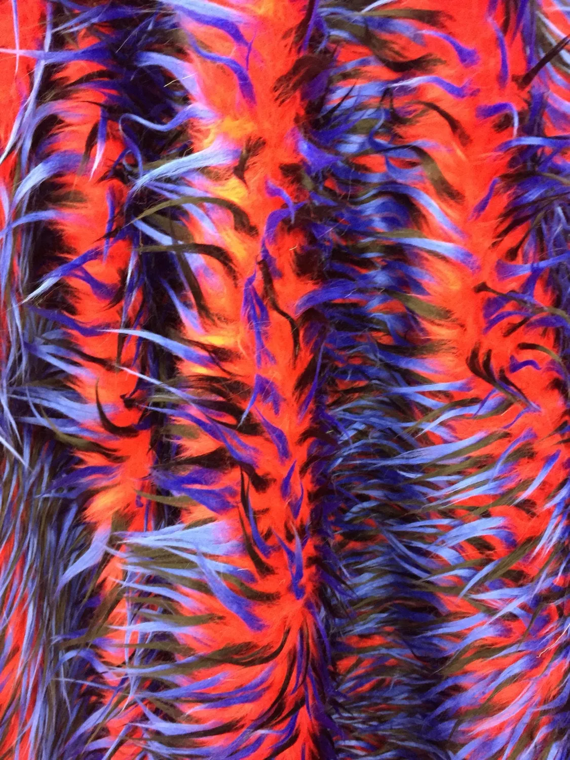 3 tone spikes faux fur- red/royal blue/black. Shaggy faux fur sold by the yard.